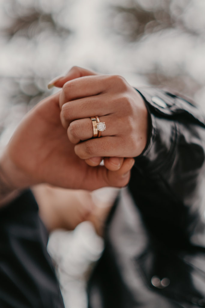 Detail portrait of bride's wedding and engagement ring.