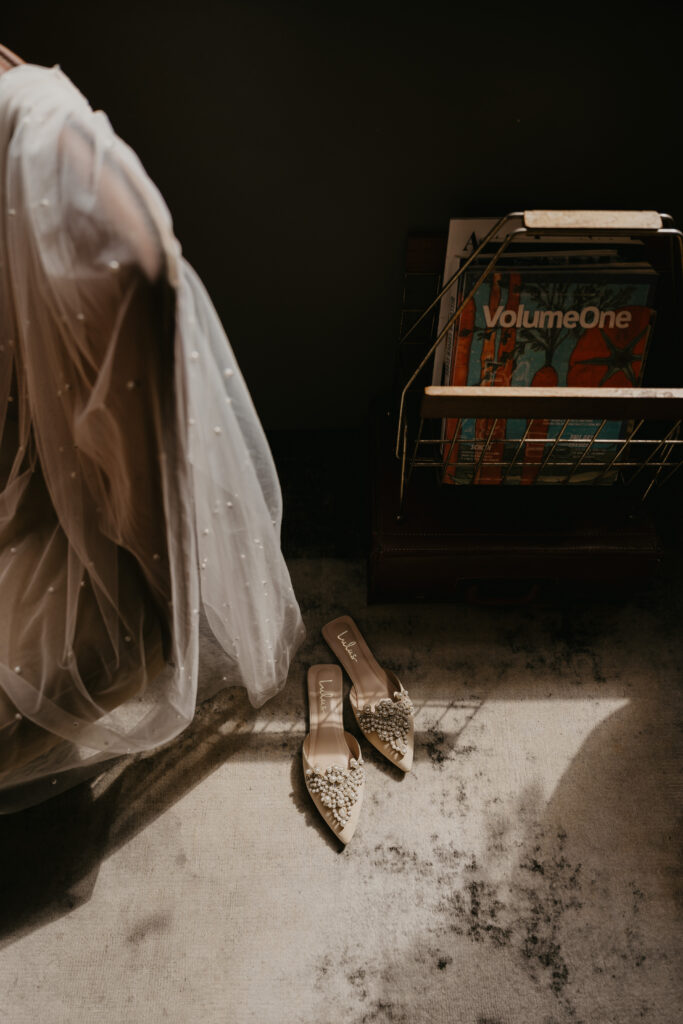 Bridal details consisting of shoes and veil, photographed inside of The Oxbow Hotel.